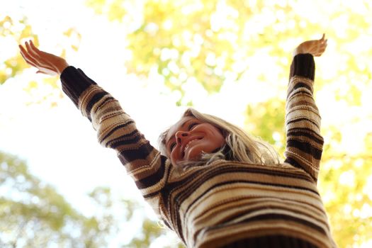 autumn woman hands in the air