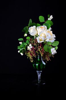 White roses bouquet in the vase on black background 