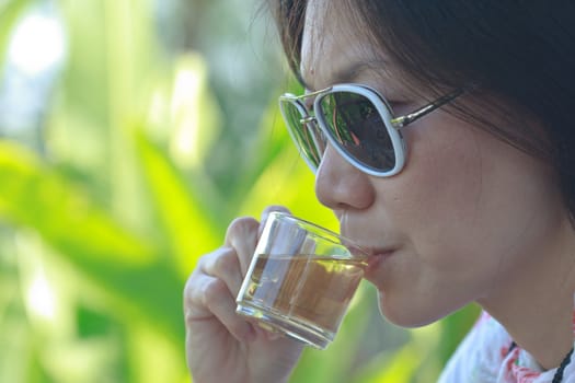 Young woman sitting drinking tea