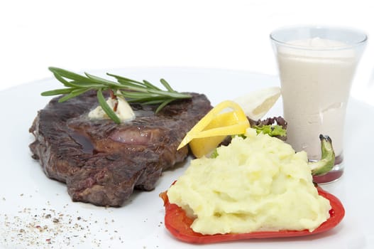 steak and mashed potatoes with gravy on a white background