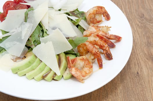 arugula dish with shrimp in a restaurant on the table