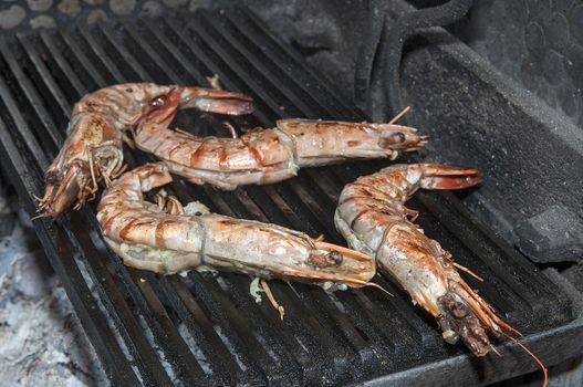 cooking shrimp on the grill in the restaurant