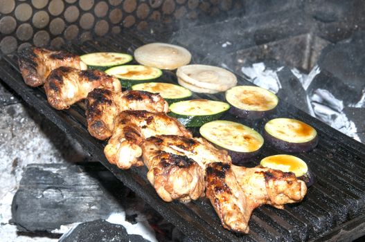 cooking chicken wings on a grill in the restaurant