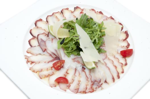 carpaccio of octopus in a restaurant on a white background