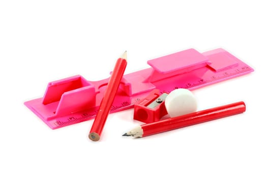 red plastic sharpener white rubber ruler and pencil to erase white background
