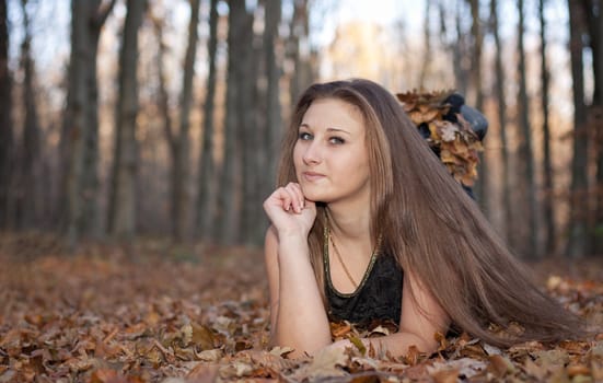 Girl on the background of autumn forest