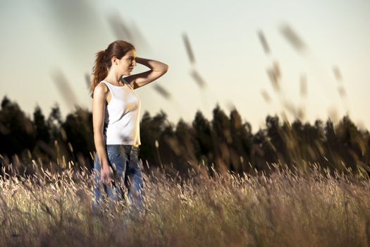 Outdoor portrait of a woman in a meadow on a summer day