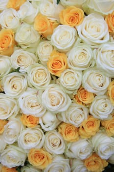 White and yellow roses in a wedding flower arrangement