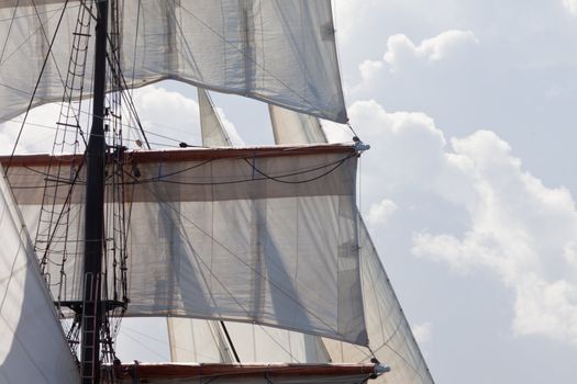 Marine or nautical background of a three masted barquentine yacht, square rigged on the foremast, with sails and rigging detail