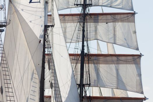 Marine or nautical background of a three masted barquentine yacht, square rigged on the foremast, with sails and rigging detail