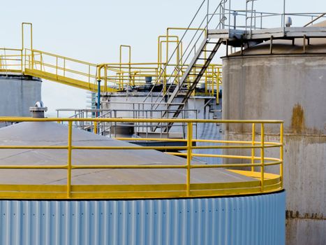 Group of large steel storage tanks at a refinery terminal used for storage and distribution of petrochemical products