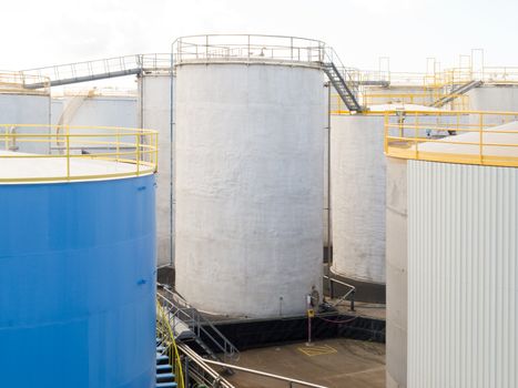 Group of large steel storage tanks at a refinery terminal used for storage and distribution of petrochemical products