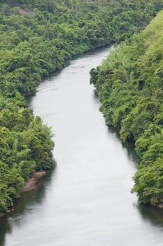 The river flows from the dam into the community.
