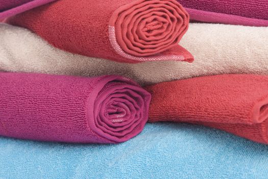 stacked of colorful towels on a white background