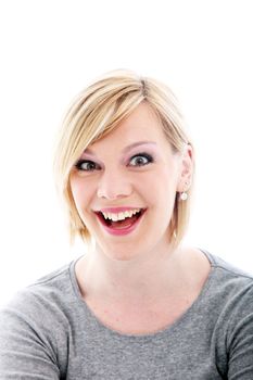 Exuberant young woman with an animated expression and wide beaming smile isolated on white 