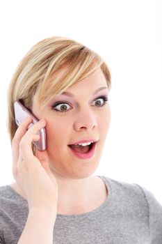 Pretty young woman talking on her mobile phone and reacting in amazement to good news isolated on white Pretty young woman ttalking on her mobile phone and reacting in amazement to good news 