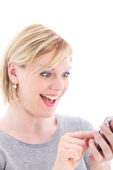 Surprised happy woman with a lovely smile texting on her handheld touch screen mobile phone Surprised happy womanwith a lovely smile texting on her handheld touch screen mobile phone 