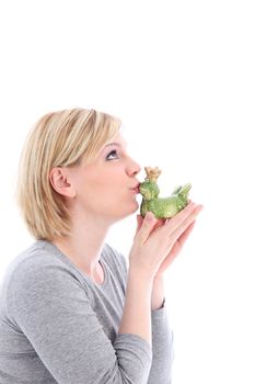 Hopeful woman kissing her ceramic frog in the hopes that it will turn into a dashing Prince charming 