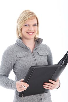 Smiling friendly young businesswoman holding a large black folder in which she has been taking notes isolated on white