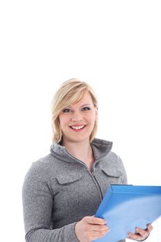 Smiling young blonde office worker standing with a blue folder in her hands isolated on white 