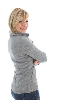 Smilimg friendly blonde woman in casual clothes standing sideways looking back at the camera isolated on white 