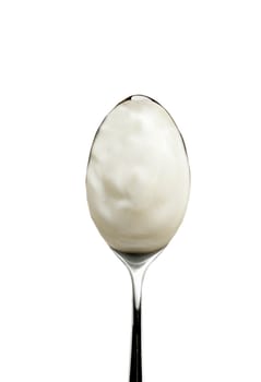 Spoon of yogurt isolated on white