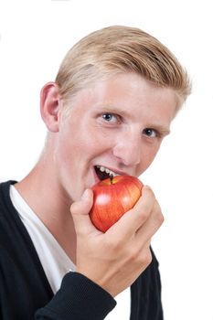 Young healthy man eating a red apple on white background