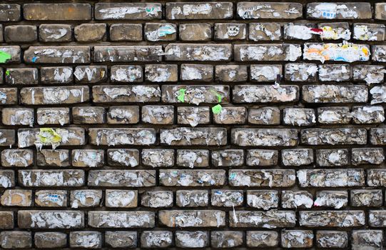 Old paper ads on aged brick wall