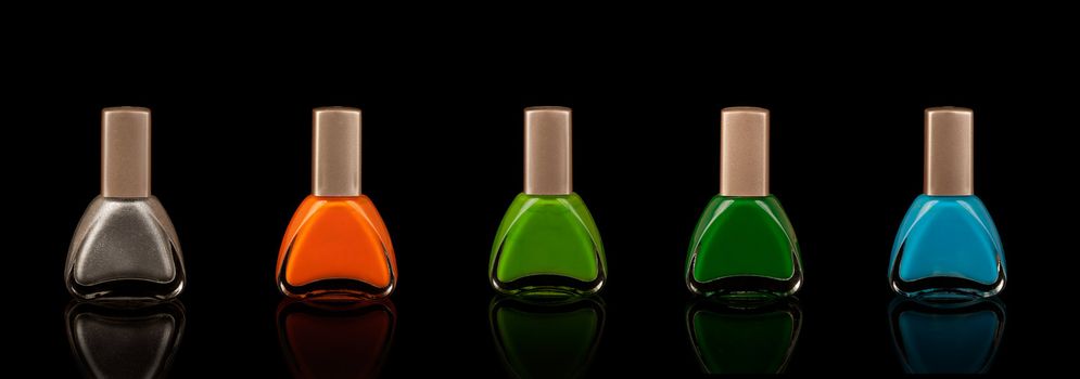 Nail polish in five colours with black background