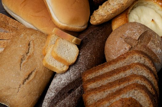 Background of Buns, Baguette, Rye and Whole Wheat Bread close up
