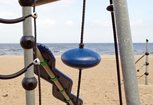 Kid playground near sea. Climbing equipment looks like UFO.