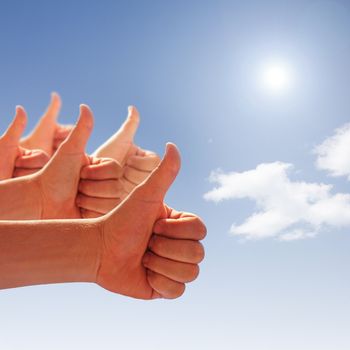 men's hands make thumbs up on blue sky