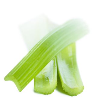 Fresh green stems of celery over white background