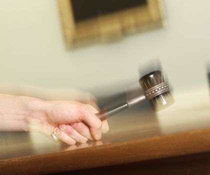 Hand Holding a Mallet on a table