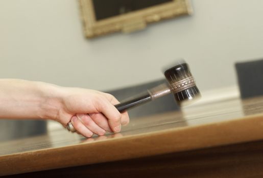 Hand Holding a Mallet on a table