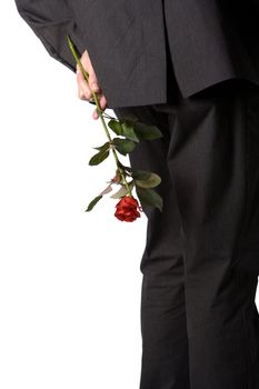 Man holding a red rose behind his back