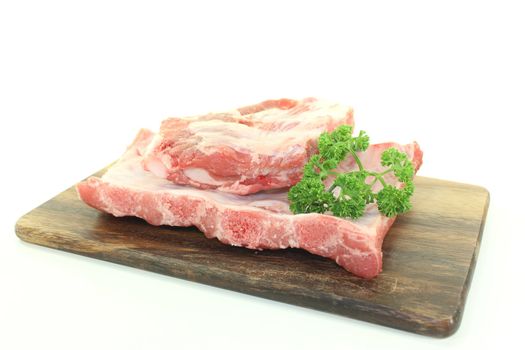 Beef spare ribs with parsley on a wooden board