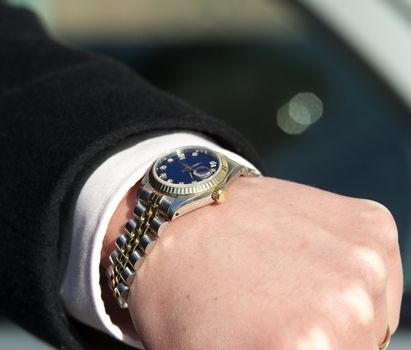 Close up of a watch on humans arm