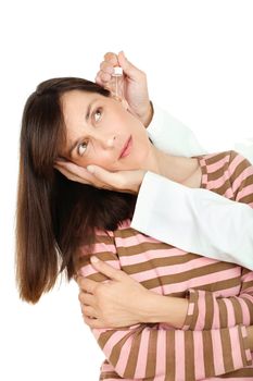 Doctor putting a drops in woman's ear 