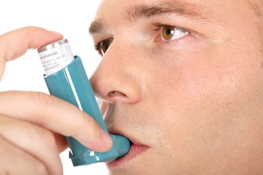 Close up look of a man with pump in his mouth, against asthma