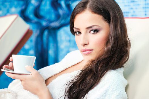 Woman enjoy cup of coffee in spa center