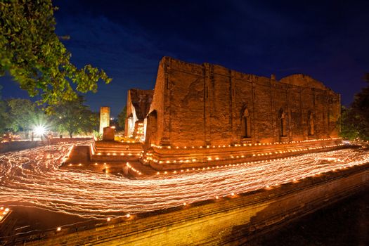 candle light trail of Buddhism Ceremony at temple ruin on Asalha Puja day
