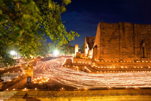candle light trail of Buddhism Ceremony at temple ruin on Asalha Puja day