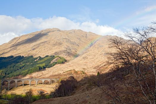 Glenfinnan Viaduct Railway Station with rainbow in Scotland UK