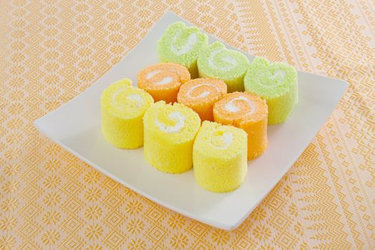 roll cake for dessert simply and freshness on orange background