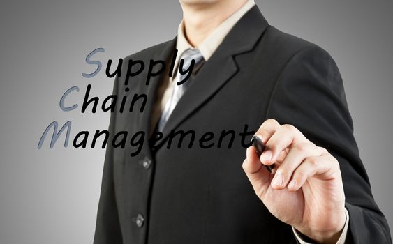 Businessman write the word supply chain management