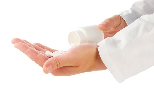 Doctor's hands with white bottle and pills on white background