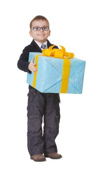 Small happy kid in spectacles with big present on white background