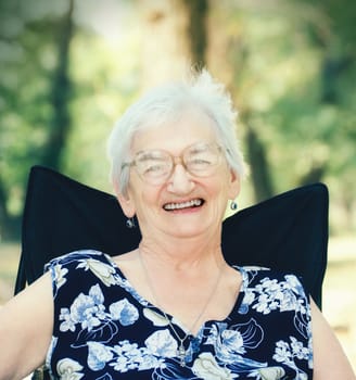 Cheerful Senior woman relaxing in the nature