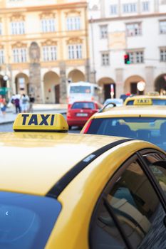 Few yellow taxi in a row on street in modern city